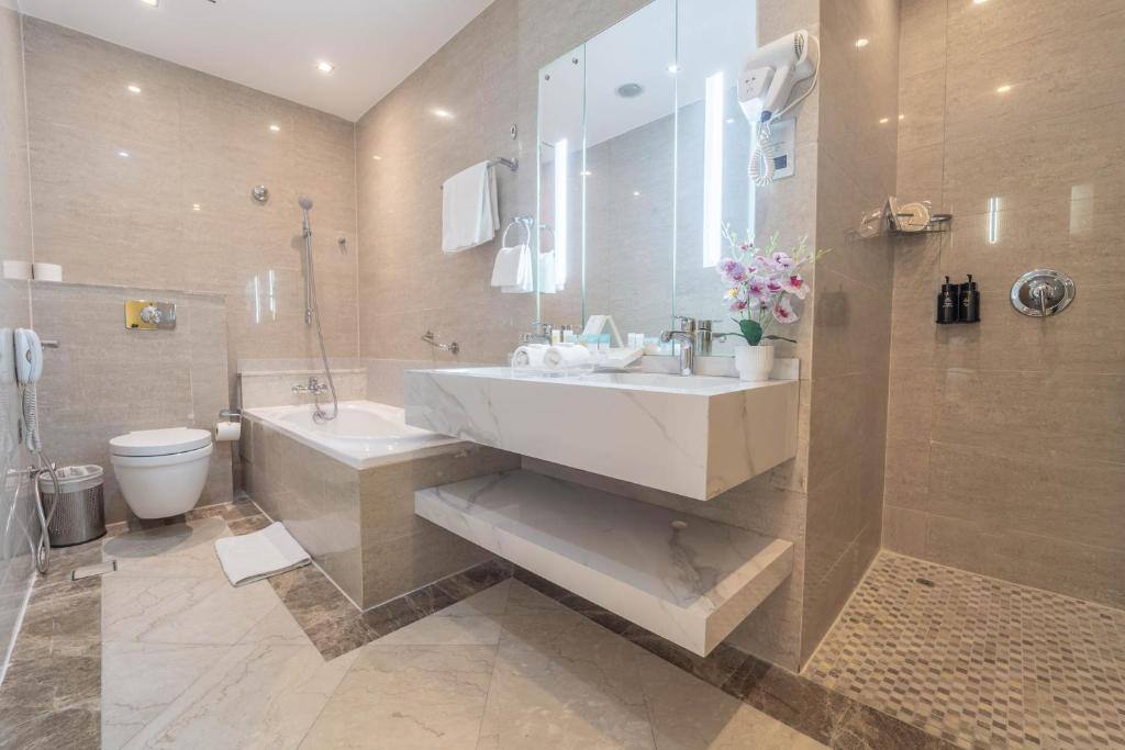Marble bathroom with bath and walk-in shower