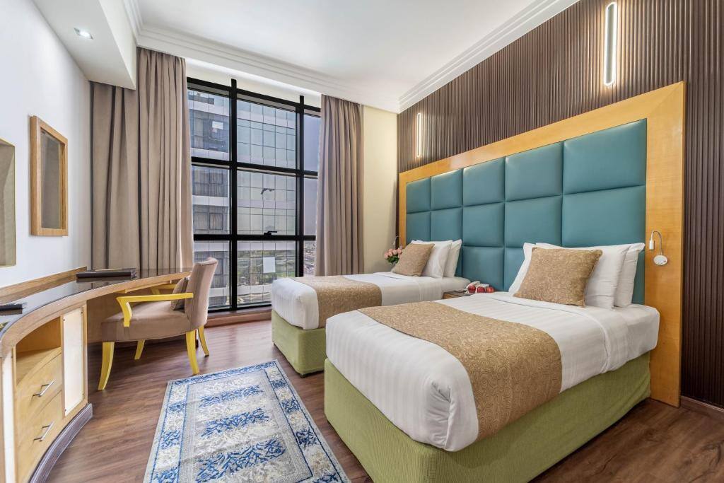 Twin room with desk and large windows